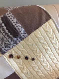 a close up of a couch cushion with buttons on the back and an ugly sweater