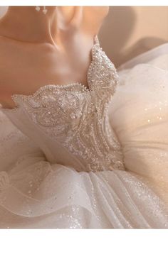 the back of a wedding dress with beading and pearls on it's neck