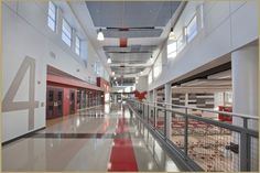 an empty hallway with red and white carpeted flooring in the middle of it