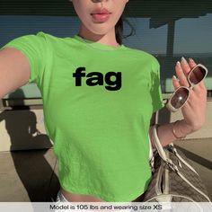 "F*g Meme LGBTQ Pride" Graphic Slogan Printed On Aesthetic Retro Vintage 90s Y2k Baby Tee Shirt with our own unique font.  🎨 Available in White, Light Pink, Light Blue, Navy, Black. If you need a different color, please let us know! (Ash, Red, Sport Grey & Green)  🎁 Our baby tees are perfect gift for her or him offering timeless fashion and versatility that anyone will cherish. Baby tees, popular in the '90s, have short sleeves and a slightly cropped body, giving a flattering feminine shape. T Y2k Green Tops For Streetwear, Y2k Green Top For Streetwear, Green Y2k Style Top For Streetwear, Green Graphic Print Y2k Tops, Y2k Green Graphic Print Tops, Green Y2k Graphic Print Tops, Y2k Green Tops With Screen Print, Y2k Style Green Tops With Screen Print, Fitted Green Y2k T-shirt