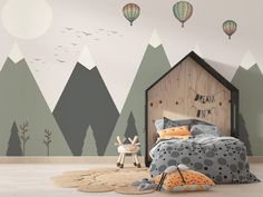 a child's bedroom with mountains and hot air balloons