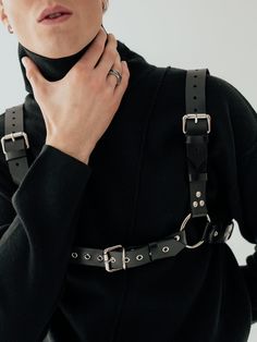 Introducing the iconic Bulldog harness - a bold and robust accessory that exudes both style and strength. Adorned with detachable chains, this versatile piece can be worn with buckles facing front or back, offering multiple styling options. Make a statement with the Bulldog - the ultimate fusion of fashion and power. Edgy Strapped Harness With Belt, Black Gothic Leather Harness, Gothic Leather Harness With Belt, Black Leather Punk Harness, Edgy Adjustable Harness With Belt, Adjustable Black Harness With Belt, Punk Style Black Harness With Adjustable Strap, Black Gothic Harness With Belt, Black Leather Harness With Belt