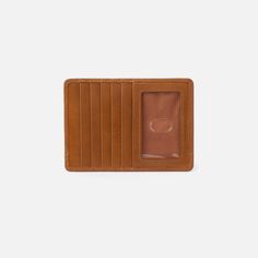 A musthave card case that doubles as a passport holder so youre always ready for the next adventure. Euro Bandana Slide Card Case in Polished Leather  Truffle Card Case in Truffle | Hobo® Rectangular Travel Wallet With Card Slots, Travel Wallets With Card Slots, Travel Wallet With Card Slots, Brown Travel Wallet, Rectangular, Brown Rectangular Travel Wallet, Trifold Wallet With Card Slots For Travel, Rectangular Trifold Wallet With Card Slots For Travel, Everyday Trifold Wallet With Hidden Phone Sleeve, Classic Travel Card Holder With Id Window