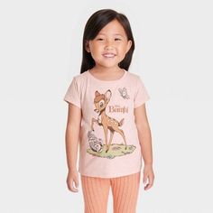 Your child will fawn over this Disney Bambi Short-Sleeve Graphic T-Shirt. The front of this pink pullover tee features an adorable illustration of Bambi, Thumper and a butterfly with the words "Disney Bambi," while the reverse features Flower and two birds. With a crewneck and short sleeves that are perfect for warm weather, the tagless T-shirt is made with a cotton blend that feels comfortable against the skin and is machine washable for easy cleaning. Disney Pink Tops With Cartoon Print, Pink Disney Cartoon Print Top, Pink Disney Cotton Top, Pink Cotton Disney Top, Spring Disney Style Short Sleeve Tops, Nightmare Before Christmas Girl, Bambi Shirt, Bambi Thumper, Disney Clothing