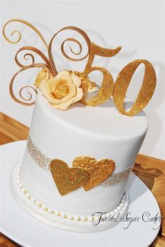 a white cake with gold decorations on top