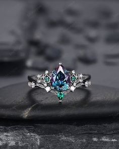 Rhodium black engagement ring like no other. This AMAZING piece of fine jewelry is the perfect expression of your eternal love. Its BLACK colors bring out the beauty of this ring. Alexandrite is the gemstone of luck, prosperity, and intellect. The alexandrite gemstone shines different colors in different lights. Under white light it shines more green and shines purple and blue under yellow light and daylight. Black gold plating pear cut lab alexandrite bridal set, black rhodium finish alexandrite wedding set, black promise ring, black wedding ring, alexandrite engagement ring set, black floral ring gift for women, girl, girlfriend, wife, mom and best friend. More black gold rings ,please click here: https://www.etsy.com/shop/ShainGem?section_id=36322715 ★Description Main ring: *Center ston Gothic Open Ring For Anniversary, Unique Multi-stone Emerald Wedding Ring, Black Multi-stone Wedding Rings, Black Multi-stone Anniversary Rings, Black Diamond Multi-stone Rings, Black Multi-stone Rings For Anniversary, Black Multi-stone Wedding Jewelry, Black Open Ring Crystal Wedding Ring, Black Open Crystal Ring For Wedding