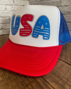 Adult  USA Custom Two Tone Glitter Puff Print Hat - Foam Hat with adjustable snapback This is the ultimate hat to wear for any USA celebration!  The designs will be in the puff colors as shown (blue and red) in pictures, but you can customize your hat by picking a hat color and glitter outline color.  **If you would like the design to have different wording, please message us and we will do our best to accommodate you Listing Reference: OTTO Cap 5 Panel High Crown Polyester Foam Front Mesh Back Trucker Hat This hat is 100% polyester and has a 5 panel seamless foam front panel with a lining matching braid.  One size fits most - Adult (6 1/2 - 7 5/8) Cheap Letter Print 5-panel Hat, 4th Of July Red Snapback Hat, Red Snapback Hat For 4th Of July, Patriotic Snapback Trucker Hat For 4th Of July, 4th Of July Adjustable Snapback Hat With Curved Brim, Patriotic Trucker Hat For 4th Of July Snapback, 4th Of July Baseball Cap Snapback, 4th Of July Curved Brim Adjustable Snapback Hat, 4th Of July Snapback Baseball Cap