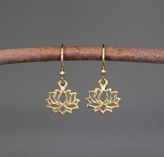 "Sweet 24k gold vermeil Lotus Flower charms simply dangle from balled 18k gold vermeil earwires. These earrings are incredibly lightweight and wonderful to wear every day. Perfect for bridal party gifts. Lotus flower: 12x12mm (including the ring at the top) Total length of earrings: almost 1\" These earrings are also available in silver... www.etsy.com/listing/992085331/lotus-flower-earrings-silver As the owner, maker, designer, and curator of this shop, I take great pride in providing you with Delicate Gold Hypoallergenic Earrings, Delicate Hypoallergenic Gold Earrings, Gold Dangle Flower Earrings In Sterling Silver, Gold Sterling Silver Dangle Flower Earrings, Delicate Gold Flower Earrings In Sterling Silver, Delicate Gold Teardrop Flower Earrings, Gold Sterling Silver Drop Flower Earrings, Gold Sterling Silver Flower Drop Earrings, Dainty Gold Flower Earrings, Pierced