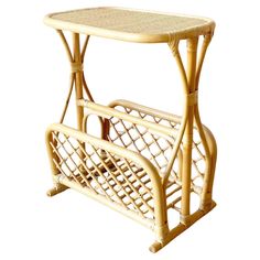 a bamboo table with a magazine rack on it's side, against a white background