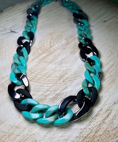 This statement necklace is ultra easy to wear, yet elegant and eye-catching. It is a great necklace that is suitable for every woman. Despite the size, it is comfortable, waterproof and does not discolour. The color turquoise-anthracite-metallic is a cool color combination, looks youthful and sporty and is still suitable for everyday use. The clasp is made of stainless steel with a 5 cm extension chain. This makes it universal even for big size. Sporty, elegant, appealing and full of life... la Trendy Resin Chain Jewelry, Trendy Green Chain Necklace With Adjustable Chain, Trendy Green Adjustable Chain Necklace, Trendy Black Chunky Chain Necklace, Trendy Black Link Chain Necklace, Good Color Combinations, Every Woman, Color Combinations, Chains Necklace