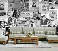 a living room filled with furniture and lots of newspapers on the wall behind it,