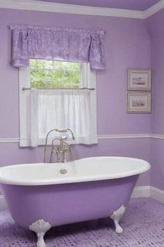 a bath tub sitting under a window next to a window sill in a bathroom