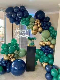 a birthday cake surrounded by balloons in the shape of a number twenty on a table