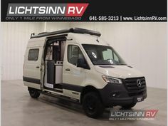 a white van parked in a garage with its door open and the words lightsin rv on it