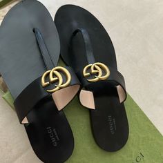 Black With Gold Hardware. Includes Original Box. Size 39. Authentic Gucci Flat Sandals. Elegant Gucci Flat Sandals, Chic Gucci Flat Sandals, Chic Black Gucci Sandals, Black Chic Gucci Sandals, Black Gucci Open Toe Sandals, Black Gucci Luxury Sandals, Gucci Black Flat Slides, Gucci Black Luxury Sandals, Luxury Gucci Round Toe Slides