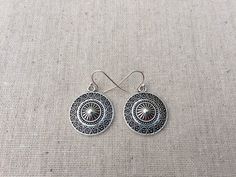 "These are unique and highly detailed boho disc earrings. They have a unique eye catching design and would be perfect for everyday wear. They measure 7/8\" across by 1\" long and hang from simple elegant ear wires. The earrings are made from allergy free plated silver. I have a matching necklace in my shop, if you would like the whole set. Here is the link https://etsy.me/2X6CB2r Thanks for stopping by. Please take a moment and visit the rest of my shop. I have many more unique jewelry designs t Vintage Round Earrings For Festivals, Southwestern Style Festival Earrings, Southwestern Style Round Festival Earrings, Southwestern Style Festival Round Earrings, Circular Festival Earrings With Hooks, Bohemian Circle Earrings With Ear Wire, Bohemian Circle Earrings, Southwestern Metal Earrings For Gift, Adjustable Southwestern Round Earrings