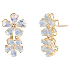 The Nina Zhou Moonstone Diamond Flower Blossom Earrings in 14k Gold epitomize elegance and natural beauty. These earrings feature luminous moonstones, renowned for their ethereal glow and adularescence, set in luxurious 14k gold. The moonstones are arranged to resemble delicate flower blossoms, each petal crafted to highlight the stone's inherent beauty and subtle, shifting colors. Enhancing the floral design, sparkling diamonds are embedded in the center, adding a touch of brilliance and sophis Convertible Earrings, Diamond Flower, Blossom Flower, Delicate Flower, Belleza Natural, Moon Stone, Baroque Pearls, Or Rose, Moonstone