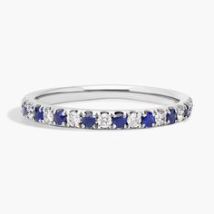 a white gold band with blue and white diamonds on it, set in 18k white gold