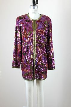 "This is a wow..with soo much sparkle!! Gold is the accent color and there are pinks and purples..really a beautiful piece!! a Long jacket, and in excellent condition! Measuring: 30\" length Width: 42\"+ Sleeves: 24\" Pet Free/smoke Free Enjoy!" Pink Embellished Winter Outerwear, Pink Embellished Long Sleeve Outerwear, Festive Long Sleeve Sequin Outerwear, Pink Fall Evening Outerwear, Pink Outerwear For Evening In Fall, Pink Evening Outerwear For Fall, Pink Glamorous Evening Outerwear, Glamorous Pink Evening Outerwear, Glamorous Pink Sequined Outerwear