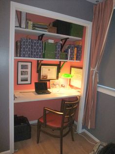 a desk with a laptop computer sitting on top of it next to a book shelf