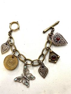 Vintage bracelet, large charms, lock then, mix of metals. Women Vintage Jewelry. Amazing jewelry for vintage lovers. Condition like new. Same as you can see on the pictures. Single copy All jewelry in my store are vintage or antique age. All jewelry is wearable. Jewelry may contain small or invisible losses that acceptable for vintage jewelry. Look carefully at the photo. I’m always in touch to answer your questions. Offer your price, we will bargain. Enjoy your shopping in my store. Enjoy to we Vintage Charm Brass Bracelet, Antique Charms Bracelets For Jewelry Making, Antique Charm Bracelet With Vintage Charm, Antique Metal Bracelet With Charms, Vintage Brass Charm Bracelets, Antique Charm Bracelet For Jewelry Making, Vintage Heart Charm Dangle Jewelry, Vintage Silver Brass Charms, Silver Brass Bracelets With Charms