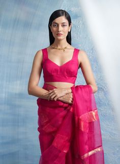 The aura shimmer organza sari in fuchsia pink is a true masterpiece from our aura collection, designed to celebrate your unique essence. Crafted meticulously from organza, this sari boasts subtle shimmer accents that delicately catch the light, casting an enchanting spell of illumination wherever you go. Paired gracefully with a linen blouse, this ensemble strikes the perfect balance between raw, natural beauty and refined confidence. The simplicity of the linen blouse accentuates the radiance o Organza Sari, Tuxedo Accessories, Beach Wedding Guests, Ritu Kumar, Summer Bride, Summer Wedding Guests, Beach Bride, Sharara Set, Linen Blouse