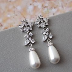 Vintage style  earrings  Colour: rhodium/silver tone/clear  /lt.ivory  Stud earrings. Length approx : 4 cm All components- rhodium over brass components, zircon crystals ,faux  white/light ivory pearls.   Great for you or for your bridesmaids. Other earrings: https://www.etsy.com/uk/shop/DonataleFlowers4You?ref=hdr_shop_menu&section_id=19125584 ❤Back to store DonataleFlowers4You: https://www.etsy.com/uk/shop/DonataleFlowers4You?ref=shopsection_shophome_leftnav In all my shop listing I have made every effort to ensure that the images match the item as closely as possible! However, colours do vary on different monitors. Some images have been enlarged to allow for details to be shown. Please read the descriptions for details on actual size of each item. Photography by STPhotography. ※Thank yo Classic Silver Chandelier Earrings For Wedding, Classic Silver Drop Chandelier Earrings, Formal Silver Chandelier Earrings With Pearl Drop, Silver Chandelier Earrings With Pearl Drop For Formal Occasions, Elegant Silver Dangle Pearl Earrings, Silver Pearl Drop Chandelier Earrings For Formal Occasions, Silver Sterling Silver Pearl Earrings For Wedding, Silver Pearl Drop Bridal Earrings For Party, Silver Teardrop Chandelier Earrings With Elegant Design