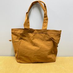 Introducing, the nylon cinch tote! This high quality bag will be your new favorite! They feature 1 main compartment for storing items! Make it a purse, tote, beach bag, and so much more. One main compartment One size slip pocket Snap closure Handles feature a 7.5” drop, for arm or shoulder carry Size is approximately 16”x14”x5” Thick & soft nylon material outer Tote Beach Bag, Wallet Shop, Accessory Pouch, Beach Bag, Snap Closure, Camel, Handles, Black Pink, Pouch