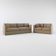 two beige couches sitting next to each other on a white floor with no one in it