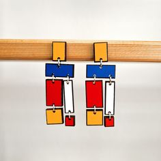 Brighten up any outfit with these beautiful Piet Mondrian-inspired earrings!  Handcrafted with wooden beads Perfect for occasions of all kinds and everyday wear, these eye-catching earrings will become your go-to accessory!  Lightweight and comfortable, they feature a drop design to complete your look with beautiful art-inspired details. The earring posts are hypoallergenic and are nickel and lead free. * Handmade item * Materials: Wood * Hypoallergenic Earring Posts * Lightweight earrings * Las Artsy Multicolor Rectangular Earrings, Composition Abstract, Patina Jewelry, Hand Painted Gifts, Abstract Earrings, Earrings Art, Earrings Colorful, Drop Design, Clay Art Projects