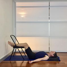 a man laying on the floor in front of a chair