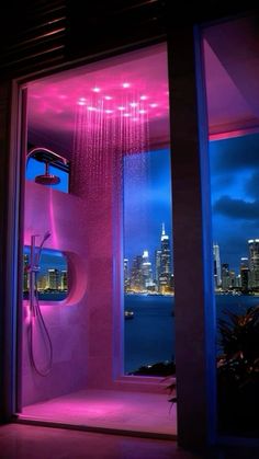 a shower head in the middle of a bathroom with city lights on it's walls