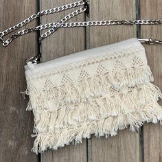 Our fun and flirty crossbody bag is perfect for beachy vacations and casual Summer travels. A tassel fringe trim on one side paired with a sleek silver chain crossbody strap in a slim profile that is perfect for carrying just the essentials. DetailsMini size exterior dimensions are 7.5in L x 5in HNatural canvas exteriorCotton fringe trim on one side (back is canvas)48 inch crossbody length. Flat sided chain for comfortable carry.Lined in a bold tropical print7 inch zippered closureDurably handcr Fringe Crossbody Bag, Boho Fringe, Tassel Fringe, Boho Vibe, Fringe Trim, Neutral Color, Summer Travel, Crossbody Strap, Neutral Colors