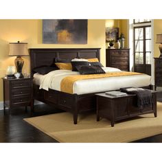 a bedroom scene with focus on the bed, dresser and footboard set's