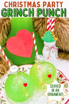 christmas party grinch punch served in an ornament on a plate with two green apples