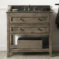 a bathroom vanity with drawers and a sink in the corner next to a towel rack