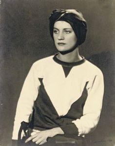 an old black and white photo of a woman with a turban on her head