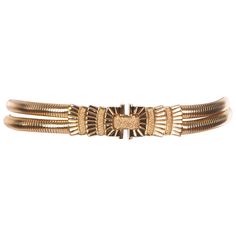 Synonymous with American luxury, Judith Leiber handbags and accessories are stylish, sophisticated and often whimsical. This is an eye-catching and elegant signed and dated Judith Leiber gold tone double serpentine strap metal belt. The beautiful radiant Art Deco-esque buckle is set with clear crystals and clasps at the front with a concealed hook. It is engraved with the Judith Leiber signature and the year 2005. The belt has quite a bit of stretch and will fit a variety of waist sizes. Please Judith Leiber Handbags, Laura Bush, Nancy Reagan, Estilo Art Deco, Metal Belt, Judith Leiber, Chatelaine, Clear Crystals, Sleek Look