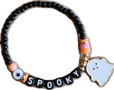 a bracelet with two charms on it that says spooky