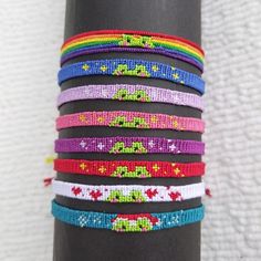 a stack of bracelets sitting on top of a black pole