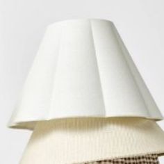 a lamp that is sitting on top of a white table with a checkered cloth covering