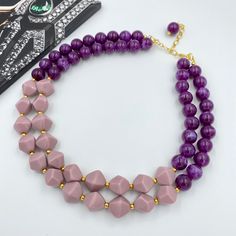 This beautiful Purple Chunky Necklace is completely handmade with high quality. It can be worn with everything and everywhere, at a holiday party or after work with friends! This is a handcrafted necklace, uniquely designed with attention to every detail. Necklace length  is 17.5" shortest strand plus additional 3 inch extender chain for length adjustment. Matching earrings are BONUS! Made of acrylic dark purple with marble effect 14 mm beads in combination with pale pink 17*16 mm beads that mak Purple Statement Necklace, Autumn Necklace, Christmas Necklace, Purple Necklace, Pink Necklace, Handcrafted Necklace, Halloween Jewelry, Marble Effect, Chunky Necklace