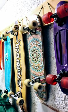 several skateboards are hanging up on the wall