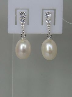 Approximately 7x8mm freshwater pearl set in a sterling silver brilliant cut cubic zirconia setting drop/dangle earrings with a butterfly fastening   The pearls I use are genuine freshwater pearls therefore each pearl is slightly different in shape, size and each pearl has its own unique natural blemishes.  will be sent in a gift box All measurements mentioned in this listing is approximate  The earrings in photo is the actual necklace and earrings you will receive The colour of the actual  earri Silver Pear-shaped Pearl Earrings For Formal Events, Silver Pear-shaped Pearl Earrings For Formal Occasions, Pear-shaped Cubic Zirconia Pearl Earrings For Anniversary, Oval White Gold Pearl Earrings For Wedding, Formal Silver Pear-shaped Pearl Earrings, Teardrop Cubic Zirconia Pearl Earrings For Anniversary, Cubic Zirconia Teardrop Pearl Earrings For Anniversary, Silver Pearl Bridal Earrings Pear-shaped, Silver Pear-shaped Pearl Bridal Earrings