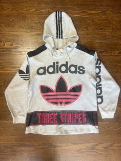 Rare Vintage 90s Adidas Trefoil Big Logo Three Stripes Hoodie & Jogger Set Step back into the golden era of streetwear with this rare vintage Adidas hoodie and jogger set from the 90s. Featuring the iconic Adidas Trefoil logo in bold, oversized print and the signature three-stripes running down the sleeves and legs, this matching set is a must-have for true collectors and vintage fashion enthusiasts alike. Crafted from soft, comfortable fabric, the hoodie offers a relaxed fit with an adjustable drawstring hood and ribbed cuffs, while the joggers feature an elastic waistband and cuffed ankles for ultimate comfort and retro style. Perfect for lounging, working out, or hitting the streets in style, this classic tracksuit set embodies the essence of 90s Adidas fashion. Details: *Authentic vint Adidas 2000 Vintage, Jogging Adidas, Ensemble Adidas, Hoodie Jogger Set, Mode Adidas, Adidas Set, Retro Sportswear, 90s Adidas, Adidas Three Stripes