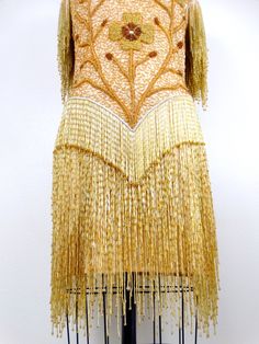 "This is an EXQUISITE heavily embellished vintage dress! It's completely hand beaded with glass beading and in excellent condition! Bust - 34-38\" Waist - 26-30\" Hips - 35-39\" Dress Length - 34\" / 38\" to the bottom of the fringe This dress comes from a pet-free and smoke-free home. If you would like more info or have any questions, please don't hesitate to ask!" Festive Couture Embellished Dresses, Festive Embellished Couture Dresses, Beaded Gatsby Style Wedding Dress, Beaded Fringe Fitted Flapper Dress For Wedding, Beaded Fitted Flapper Dress For Wedding, Fitted Beaded Fringe Flapper Dress For Wedding, Traditional Fitted Embellished Evening Dress, Fitted Couture Dresses For Festive Season, Beaded Gatsby Wedding Dress