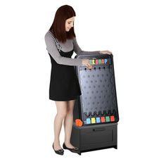 a woman standing next to an interactive game