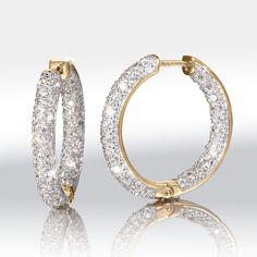 Wearable works of art. Sterling silver finished in opulent yellow gold. Prepare to be spellbound by the dazzle of these hoops. They are meticulously adorned with Diamondeau®, flawless simulated diamond, both inside and out, ensuring that they sparkle from every angle. With each movement, they catch the light and create a breath-taking display of radiance. These earrings make a wonderful gift for a loved one or a well – deserved treat for yourself. Dazzling Diamond Earrings With Accents, Fine Jewelry Hoop Earrings With Pave Setting, Classic Yellow Gold Diamond Earrings With Sparkling Stones, Luxury Halo Hoop Jewelry, Luxury Sparkling Yellow Gold Diamond Earrings, Diamond White Sparkling Huggie Jewelry, Luxury Hoop Earrings With Pave Setting, Diamond White Sparkling Stones Huggie Jewelry, Luxury Pave Set Hoop Earrings