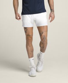 Sometimes it's not just about facing your opponent, but also the weather. The Tournament Short is Wilson's lightest-weight, on-court short for hot days. Ultralight and airy, the stretchy fabric is perforated for ventilation. The knit waistband has a mesh-like texture and a built-in drawcord, so it keeps a strong hold without feeling restrictive. Unlined and designed to pair with your favorite compression liner. | Wilson Men's Tournament Short 5" White Sportswear Activewear With 4-way Stretch, White 4-way Stretch Sportswear Activewear, White 4-way Stretch Activewear Sportswear, White 4-way Stretch Activewear For Sports, White Breathable Moisture-wicking Activewear, White Moisture-wicking Activewear In Breathable Fabric, White Moisture-wicking Breathable Activewear, White Breathable Activewear For Training, White Breathable Fabric Activewear For Training