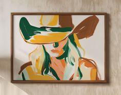 a painting hanging on the wall with a woman wearing a hat